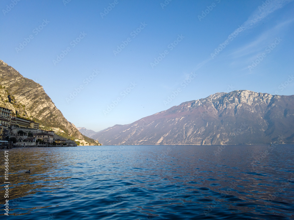 Limone Sul Garda, Italy - November 7, 2024: Cityscape with View of Lake Garda and Mountains Limone Sul Garda, Italy - November 7, 2024: Cityscape with View of Lake Garda and Mountains