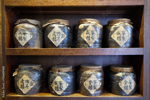 traditional chinese ceramic jars for medicine on wooden shelf