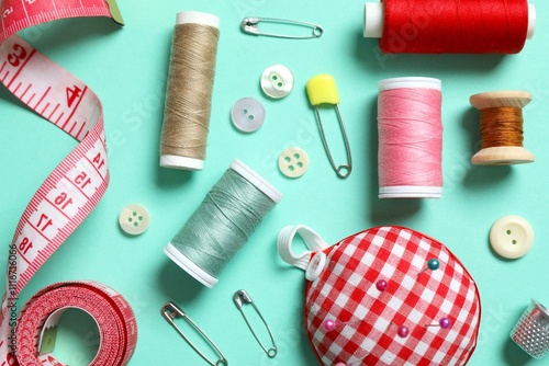 Flat lay composition with different sewing supplies on color background