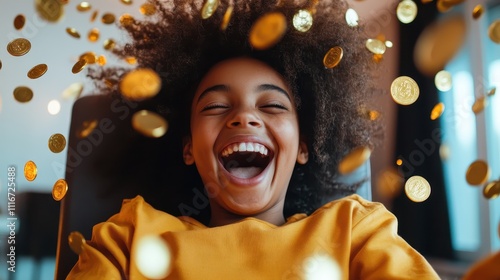 A child joyfully laughs as a multitude of golden coins cascade down around them, capturing a moment of pure happiness and wonder in a dynamic setting. photo