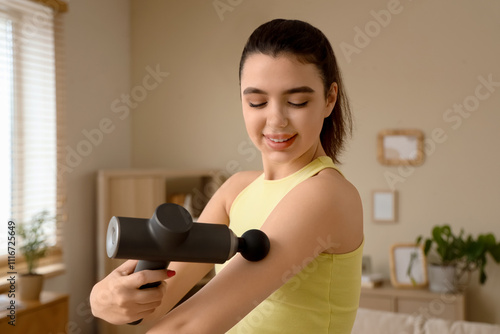 Sporty young woman massagin...