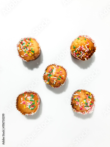 Banana muffin or banana cupcake with sprinkles with an isolated white background. Top view