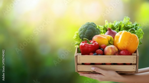 Hands passing a crate of fresh vegetables and fruits in an outdoor setting blurred green background natural daylight fresh and vibrant atmosphere