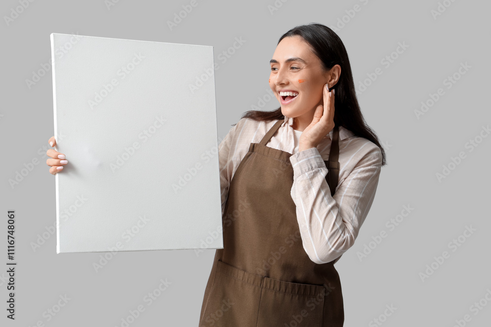 Beautiful female artist with canvas on grey background Beautiful female artist with canvas on grey background