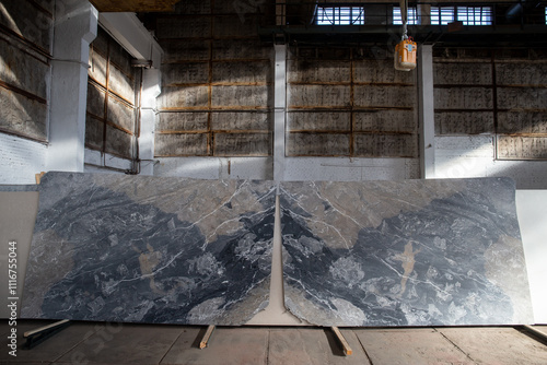 Photo of luxury grey marble slabs in warehouse.
Slabs arranged mirror-like. French marble Breche de Aubisque photo