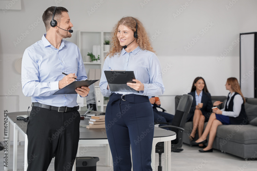 Fototapeta premium Technical support agents with clipboards in office