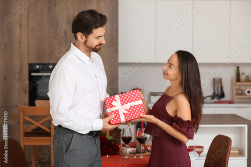 Young man giving gift box t...