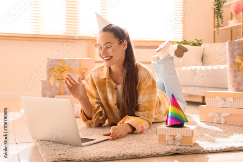 Young woman in party hat wi...