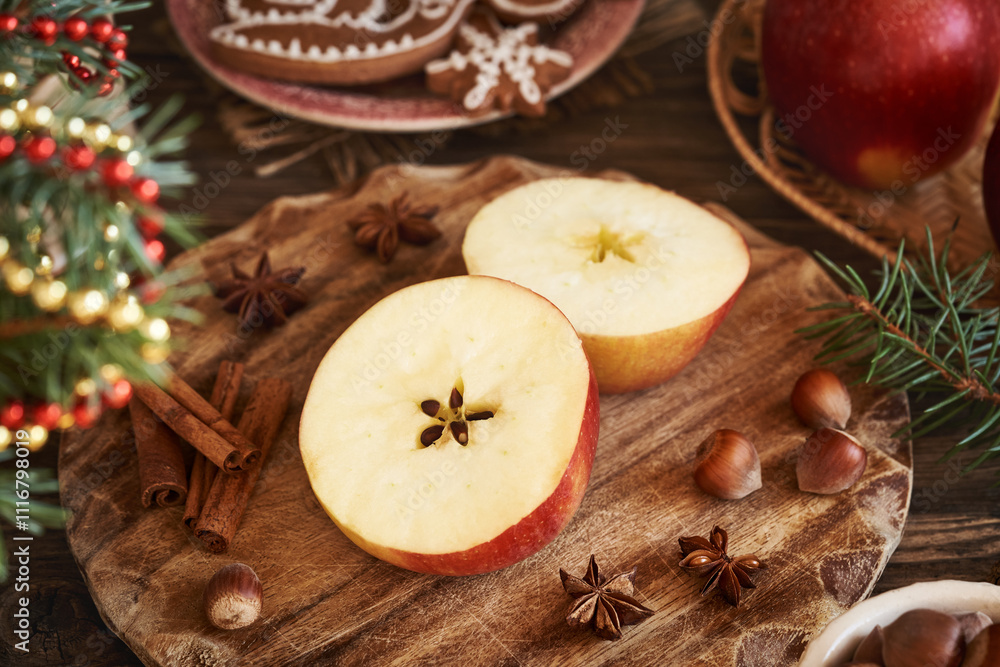Halved red apple with a star in the middle with cinnamon, star anise and Christmas decoration Halved red apple with a star in the middle with cinnamon, star anise and Christmas decoration