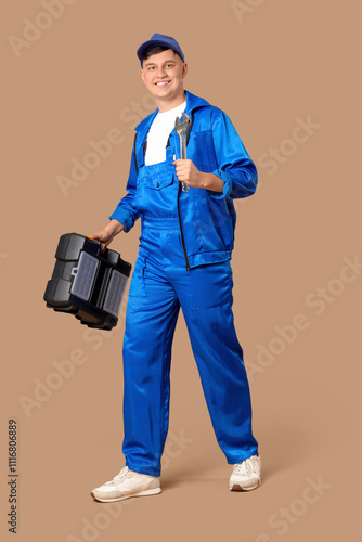 Male worker with wrench and...