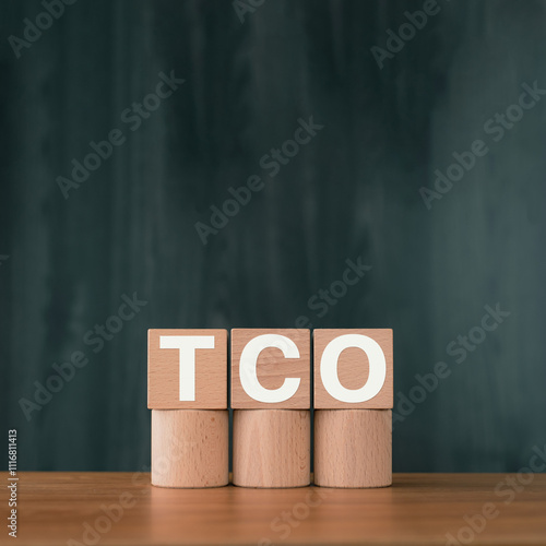 There is wood cube with the word TCO. It is an abbreviation for Total Cost of Ownership as eye-catching image. photo