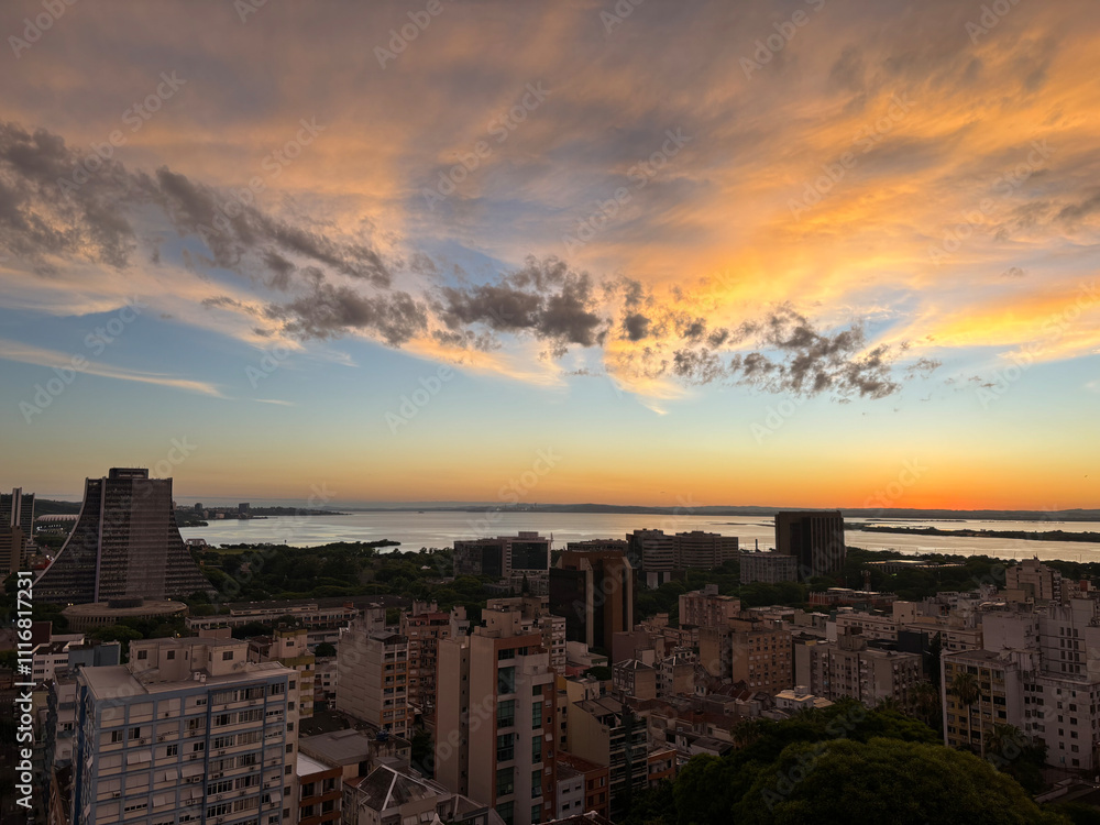 Fototapeta premium Aerial view of the central area of Porto Alegre with the Guaiba River in the background - sunset with clouds