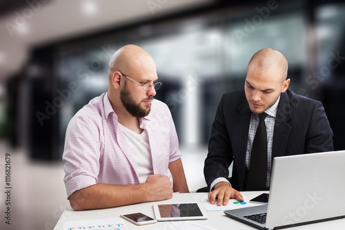 Two happy professional business people together in modern office