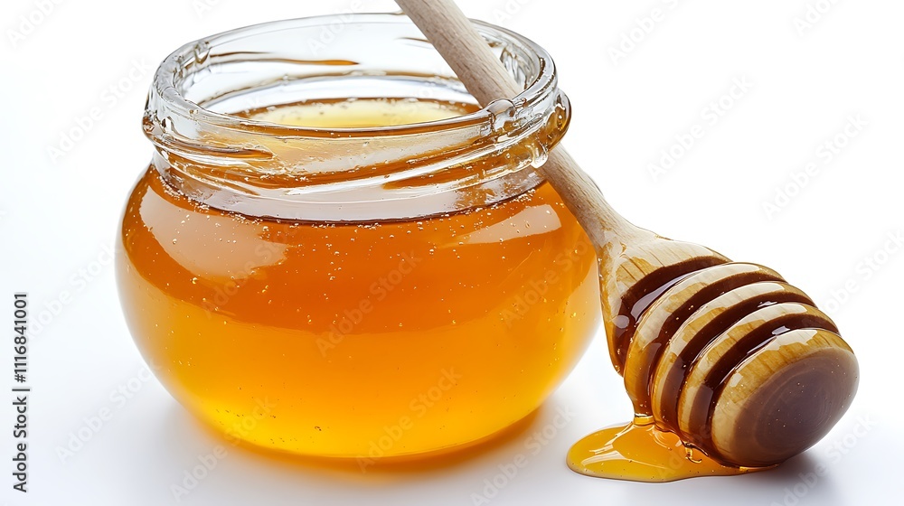Golden honey in a glass jar with a wooden honey dipper. Golden honey in a glass jar with a wooden honey dipper.