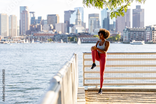 Young healthy black woman stretch leg photo