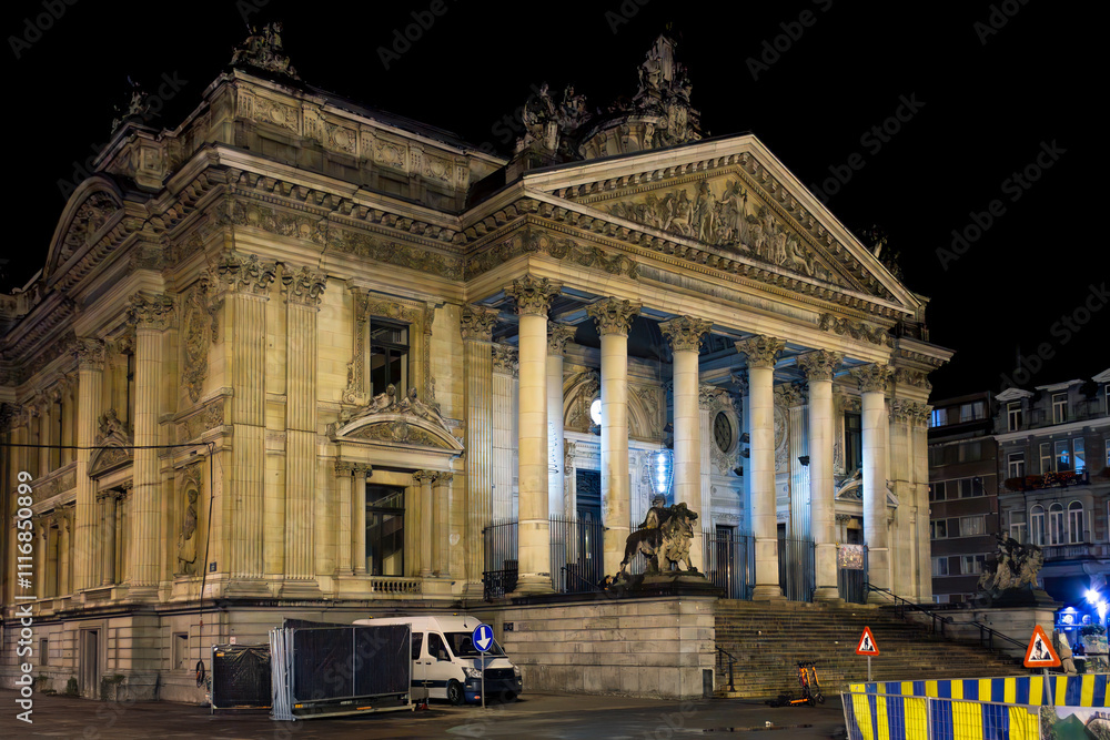 Fototapeta premium Late night view of the facade of the historic Brussels Stock Exchange building founded in 1802 by Napoleon in the Place de la Bourse, or Beursplein, in Brussels Belgium. 