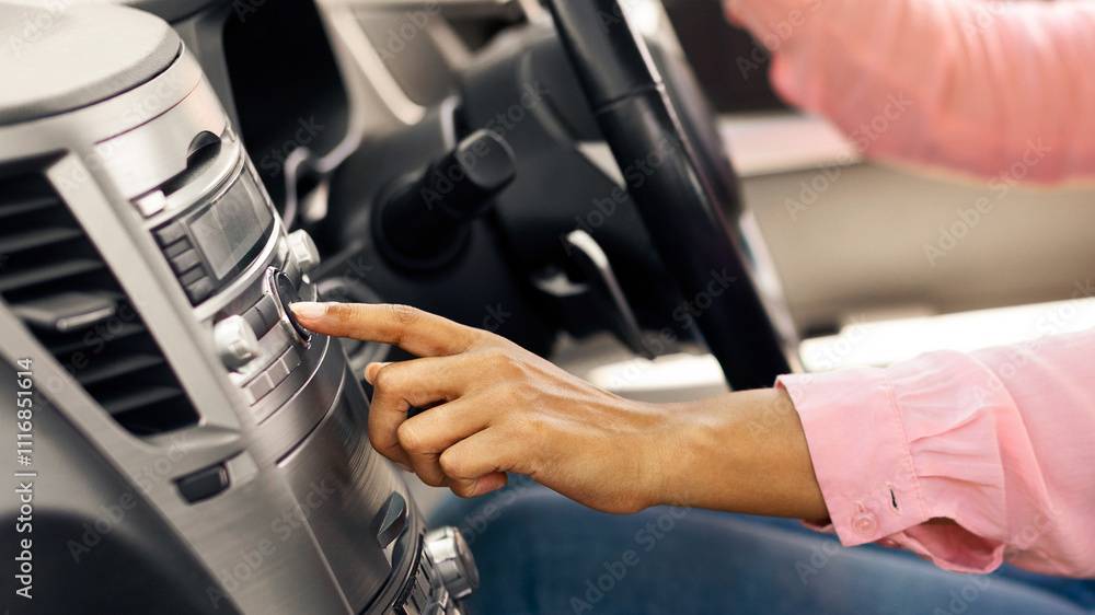 Obraz premium Closeup Of Cheerful African American Lady Changing Radio Station Listening Music In Car, Enjoying Automobile Audio System, Testing Her New Vehicle Pushing Button Turning Volume Up, Profile Side View