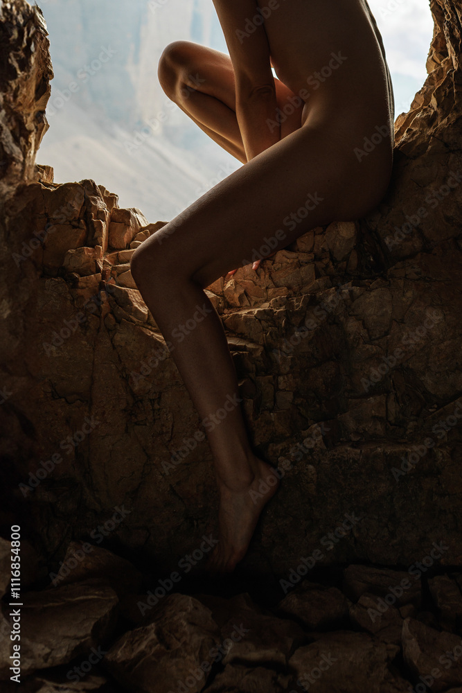Barefoot Woman's Legs in Rocky Cave with Mountain View Barefoot Woman's Legs in Rocky Cave with Mountain View