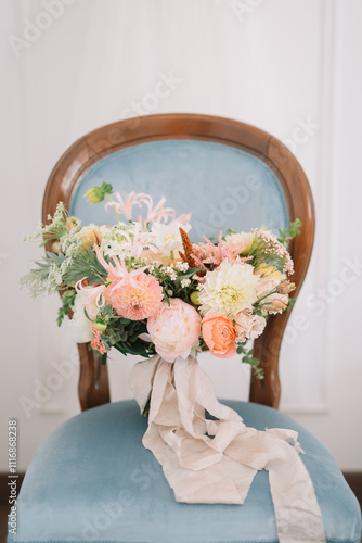 Mixed flower bouquet with soft cloth ribbon on chair photo