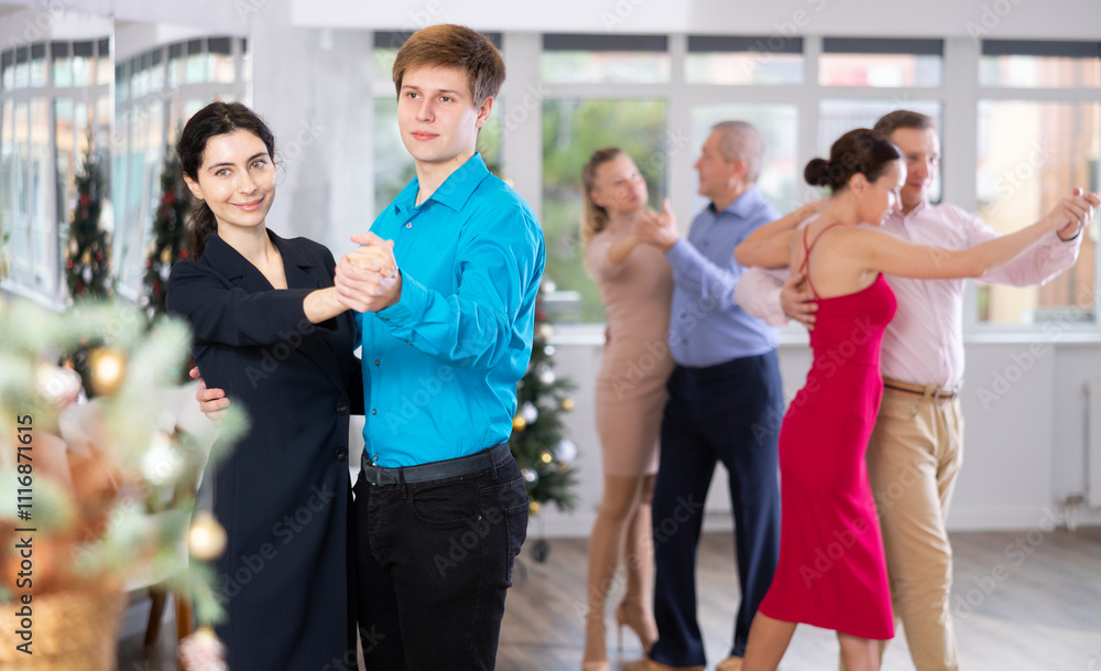 Fototapeta premium Young couple rehearsing and dancing in dance class