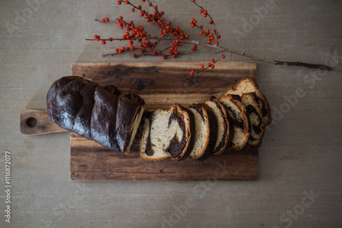 Artisan chocolate swirl bread loaf on a rustic table. photo