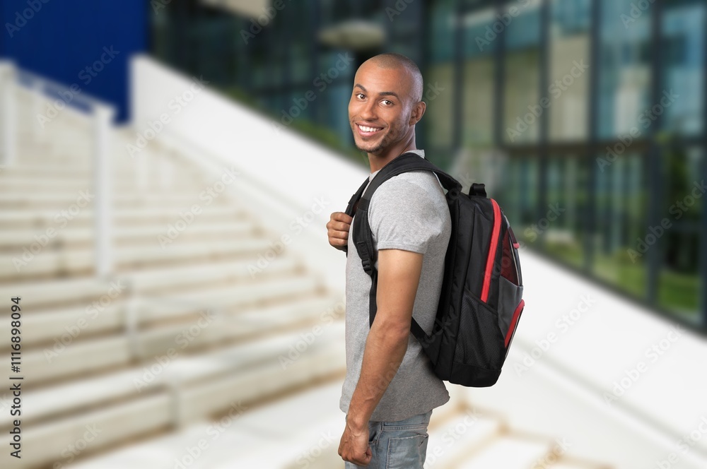 Portrait of smiling young student standing in university campus Portrait of smiling young student standing in university campus