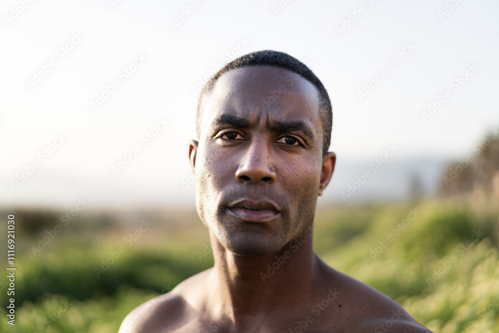 Serious black man with a short haircut standing outside Serious black man with a short haircut standing outside