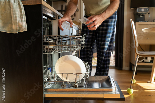 Man Using Dishwasher photo