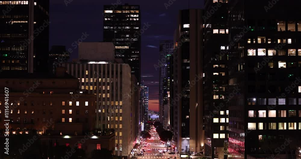 Los Angeles, California, USA - November 29, 2024: Evening traffic streams down Flower Street through the Financial District of Downtown LA. Los Angeles, California, USA - November 29, 2024: Evening traffic streams down Flower Street through the Financial District of Downtown LA.