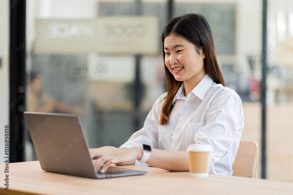 Portrait of a business asian woman sitting in an office with her colleagues in the background. Happy business woman working in a co-working office.
Portrait of a business asian woman sitting in an office with her colleagues in the background. Happy business woman working in a co-working office.