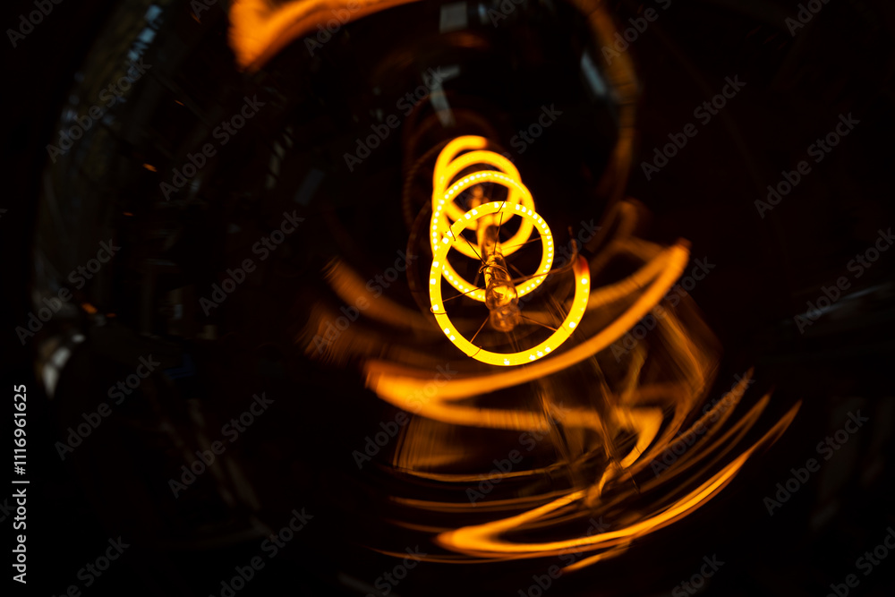 Fototapeta premium Innovation and energy concept. Close up glowing light bulb. Close-up of incandescent light bulbs. Inefficient filament light bulbs. Electricity. Decorative edison light bulbs.