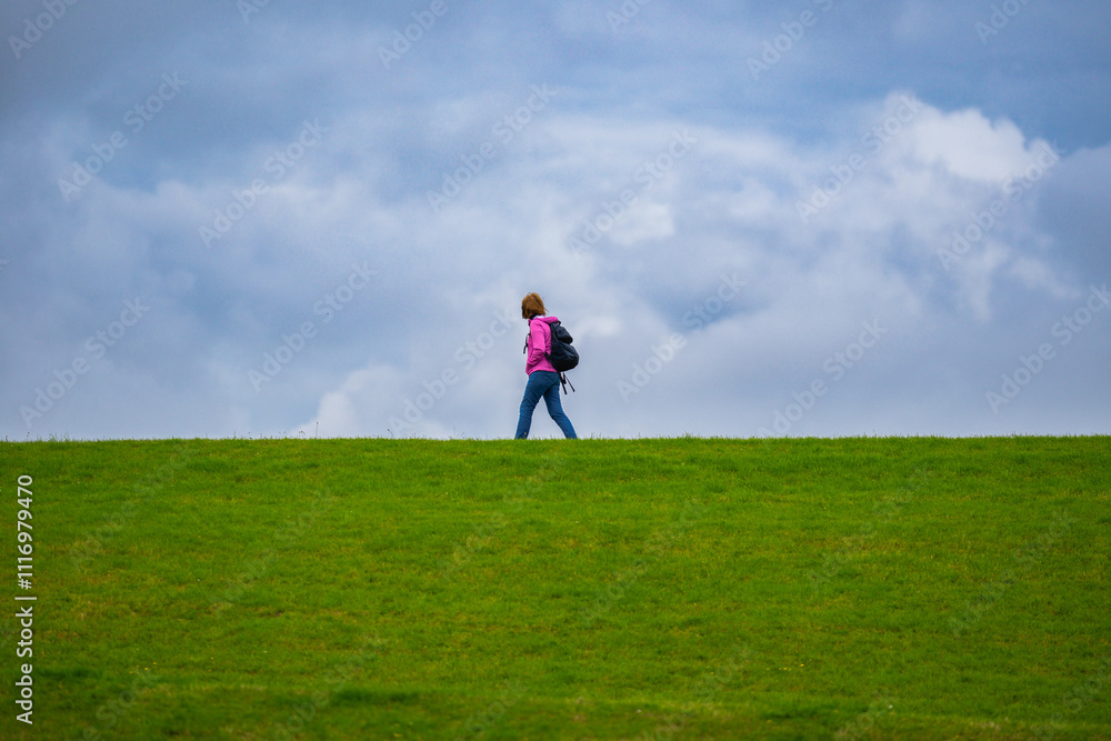 Woman with backpack. Hiking. Travel and tourism. The Hiking. Woman with backpack at field. Hiking trail. Woman with backpack. Hiking. Travel and tourism. The Hiking. Woman with backpack at field. Hiking trail.