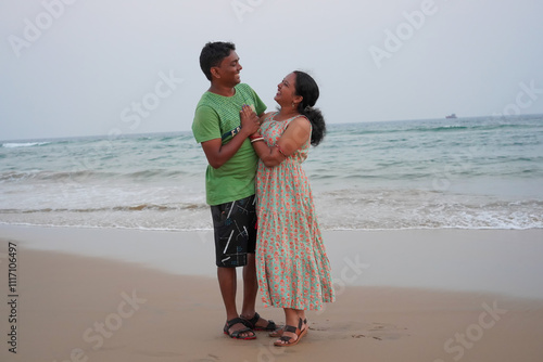 Man and woman couple smiling confident hugging each other at sea side. Indian couple in love at Puri sea beach, Odisha in India.