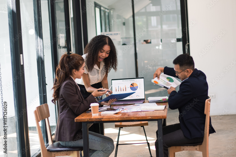 Asian businessmen come together to analyze market data.