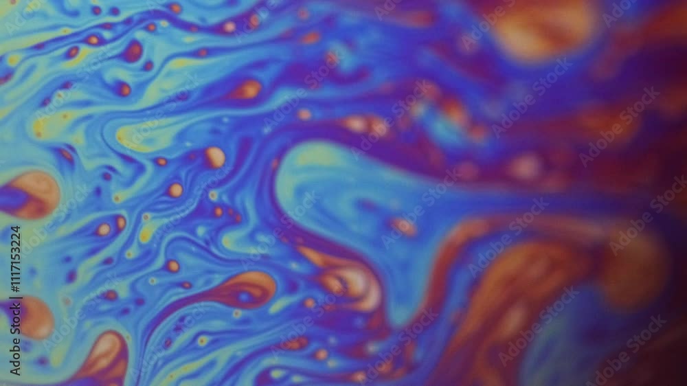 Gasoline rainbow. Paint mix. Defocused orange pink blue color spectrum oil dye droplets flow motion abstract art background. Gasoline rainbow. Paint mix. Defocused orange pink blue color spectrum oil dye droplets flow motion abstract art background.
