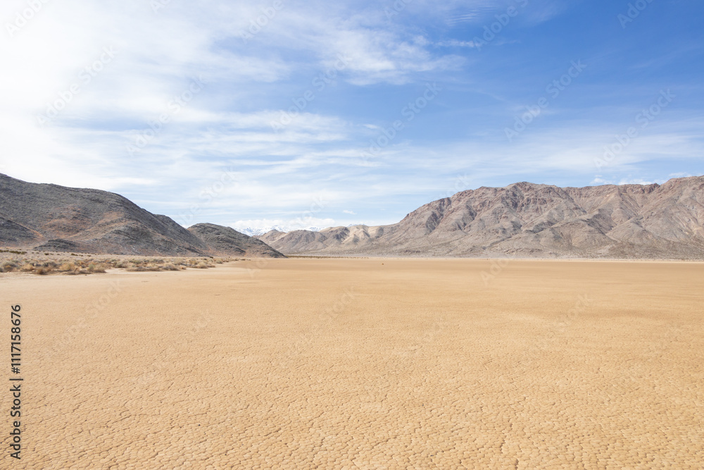 Moving rocks in the dry lake bed at The Racetrack at Death Valley National Park, California