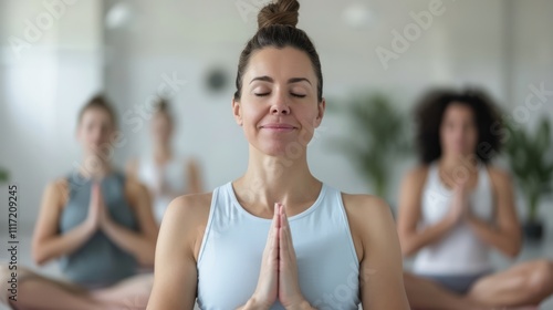 Free Download Calm and Serene Group Yoga Practice in a Bright Studio with Focused Participants Meditating Together for Mindfulness and Inner Peace - GFXLoad