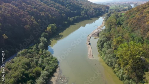 Sand and gravel exploitation in the river aerial view by drone