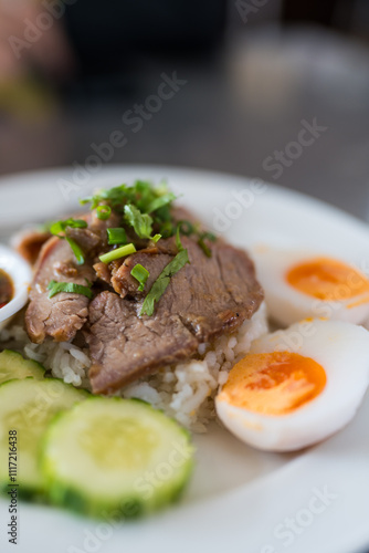 Wallpaper Mural Slice of stewed pork eaten with rice served with boiled egg and cucumber sprinkled with coriander. Close up Torontodigital.ca