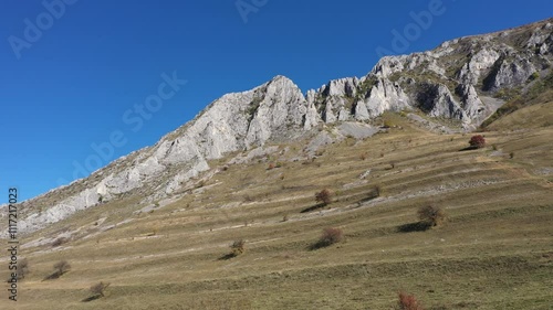 Flying above huge mountain ridge, limestone cliffs aerial. Piatra Secuiului, Szekelyko, Romania by drone