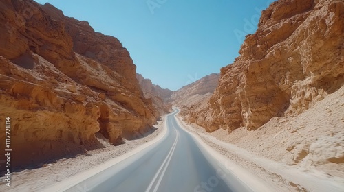 Winding road through a deep canyon with sheer rock walls and bright desert skies, Canyon road, Dramatic, scenic, adventurous