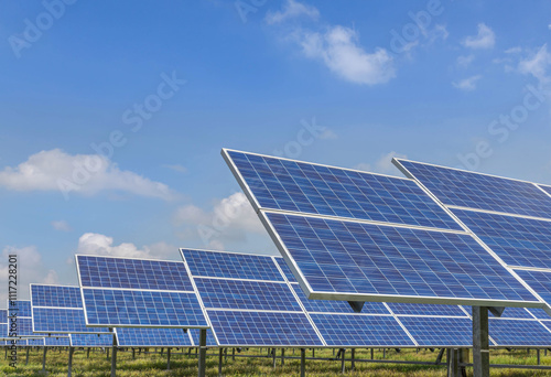    Close up rows array of Solar panels or solar cells or photovoltaics in solar power station on blue sky , clean energy power sustainable energy environmentally friendly