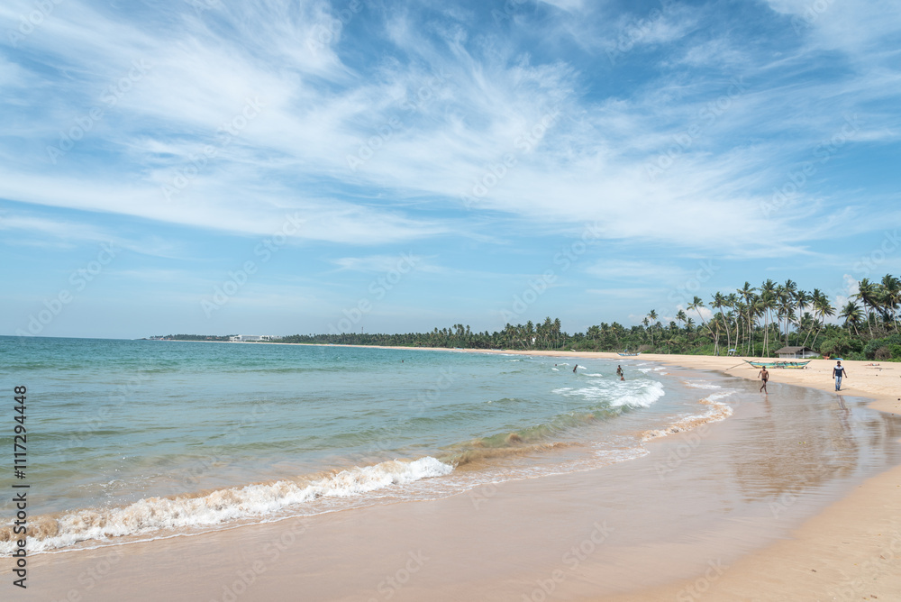 Expansive tropical ocean view with gentle waves under a bright, clear sky. Tropical beach and clear sky in afternoon. Perfect vacation getaway Expansive tropical ocean view with gentle waves under a bright, clear sky. Tropical beach and clear sky in afternoon. Perfect vacation getaway