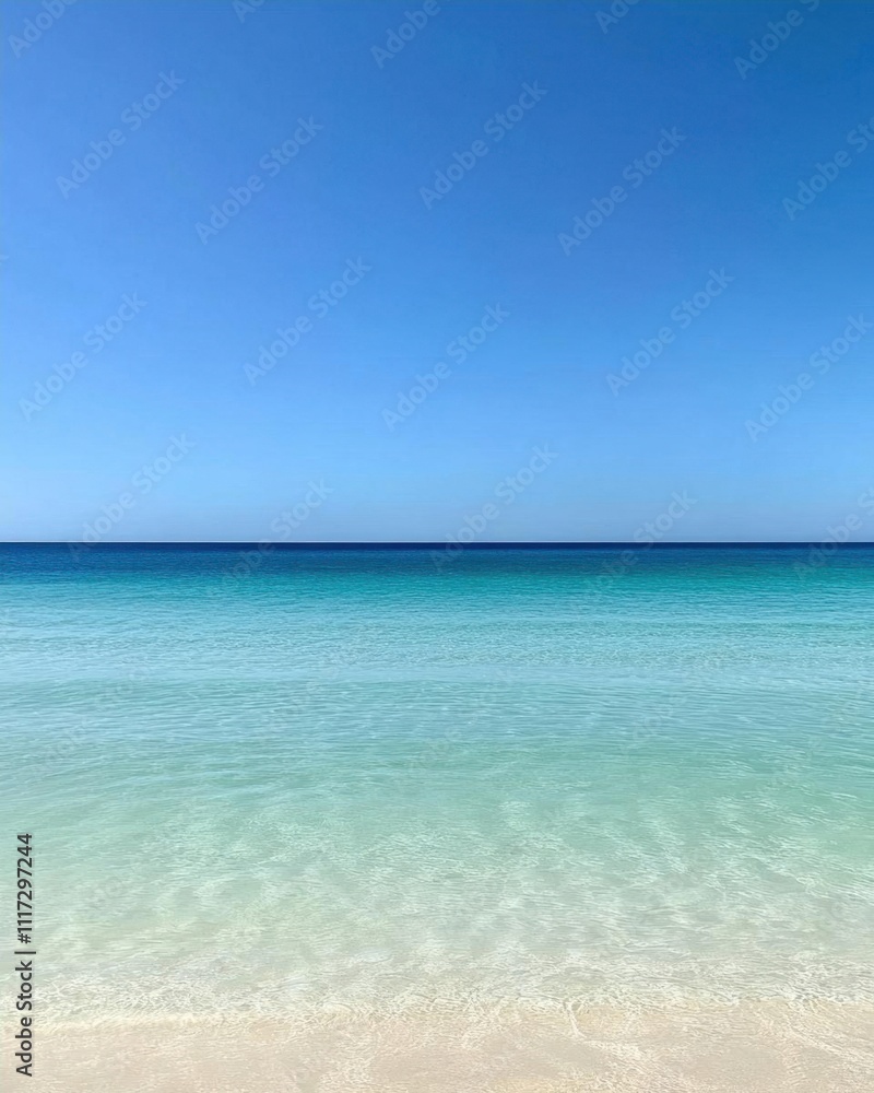 A serene beach scene with clear water and a blue sky.