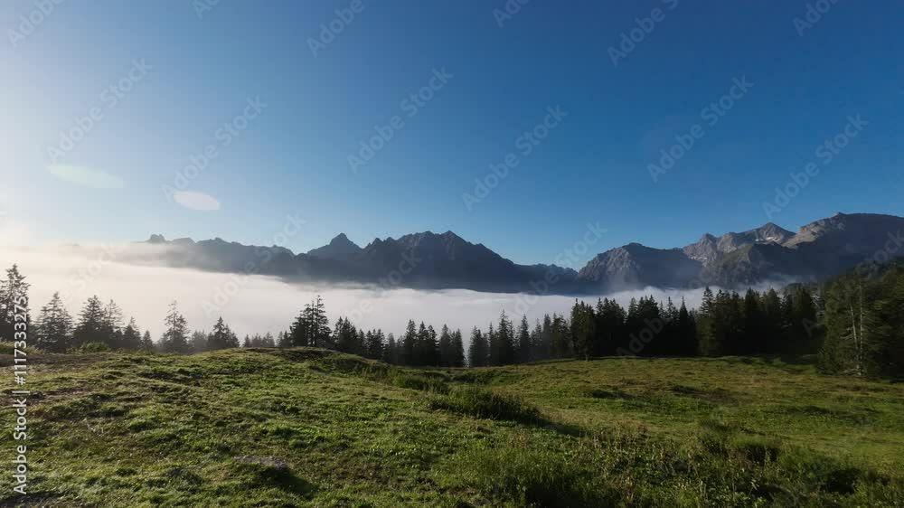 Timelapse of Clouds flying over Mountain Range in Nature in Alpine Mountain Landscape. Sunny Morning Weather with Fog Timelapse of Clouds flying over Mountain Range in Nature in Alpine Mountain Landscape. Sunny Morning Weather with Fog