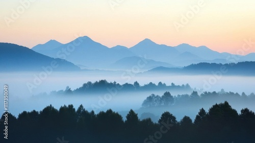 Serene mountain landscape shrouded in mist during dawn.