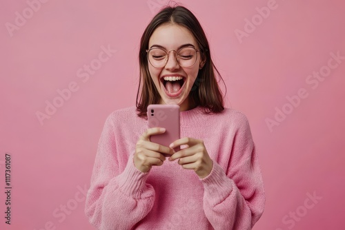 Young happy lucky woman student feeling excited winner holding cellphone using mobile phone