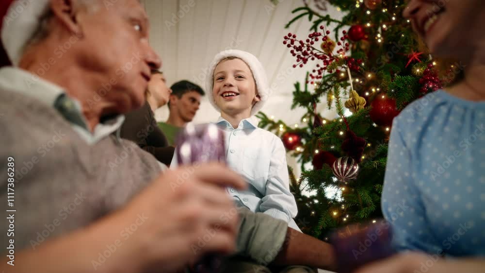 Granddad drinking champagne in Christmas eve and joyful little boy laughing. Happy family celebrating winter holidays, merry Xmas and happy New Year, slow motion, cozy atmosphere in beautiful home Granddad drinking champagne in Christmas eve and joyful little boy laughing. Happy family celebrating winter holidays, merry Xmas and happy New Year, slow motion, cozy atmosphere in beautiful home