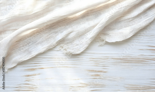 Elegant off-white linen fabric draped on a rustic white wooden background. Perfect for blogs, websites, and design projects needing a textured backdrop.