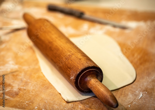 Traditional wooden rolling pin for rolling dough photo